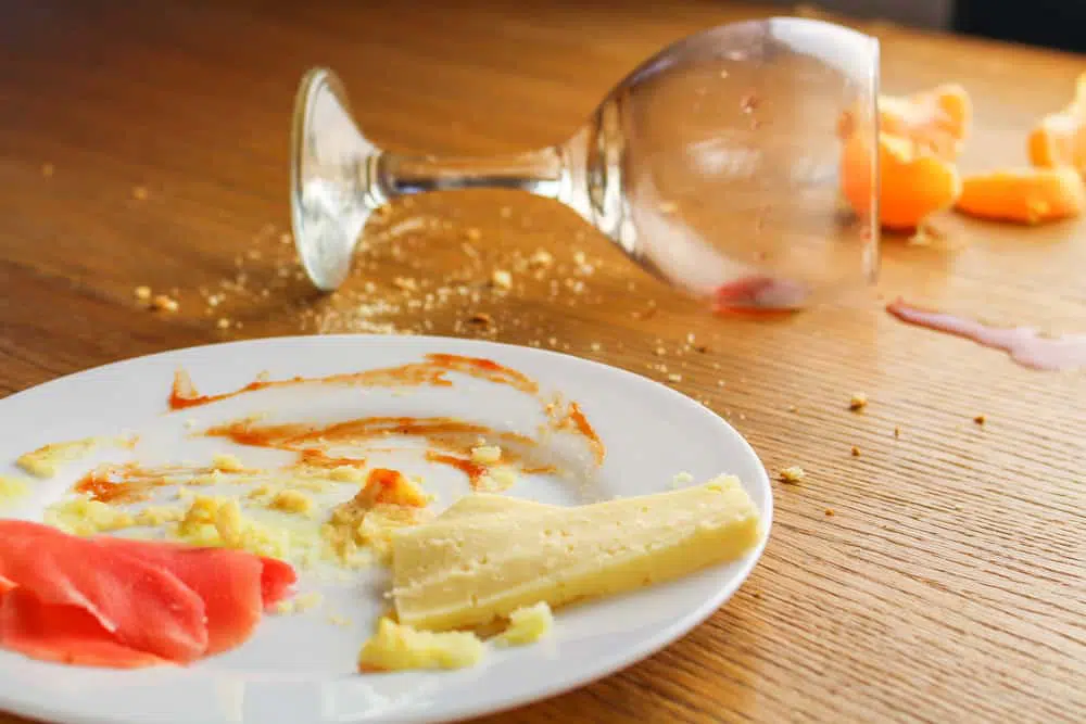 Image of a spilled wine glass and food