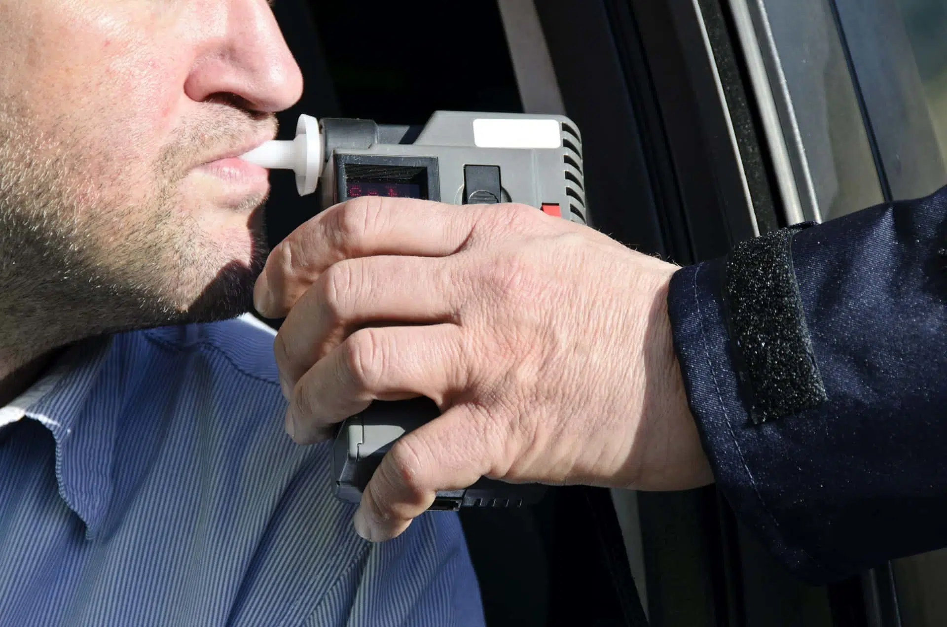 Image of a man giving a breathalyzer test after being stopped at a Murrieta DUI checkpoint that resulted in multiple arrests.