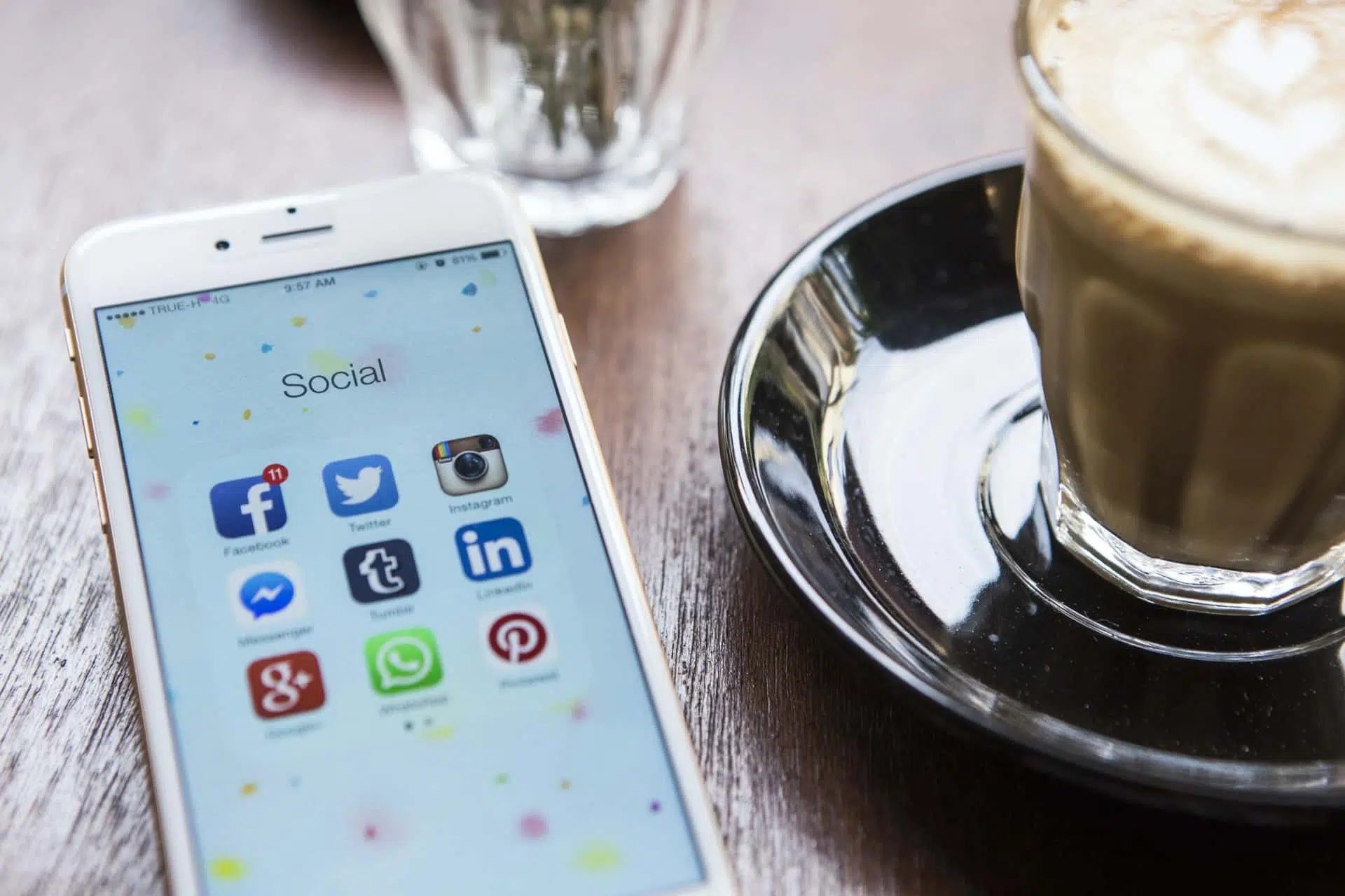 Cell phone with social media notifications open at a coffee shop