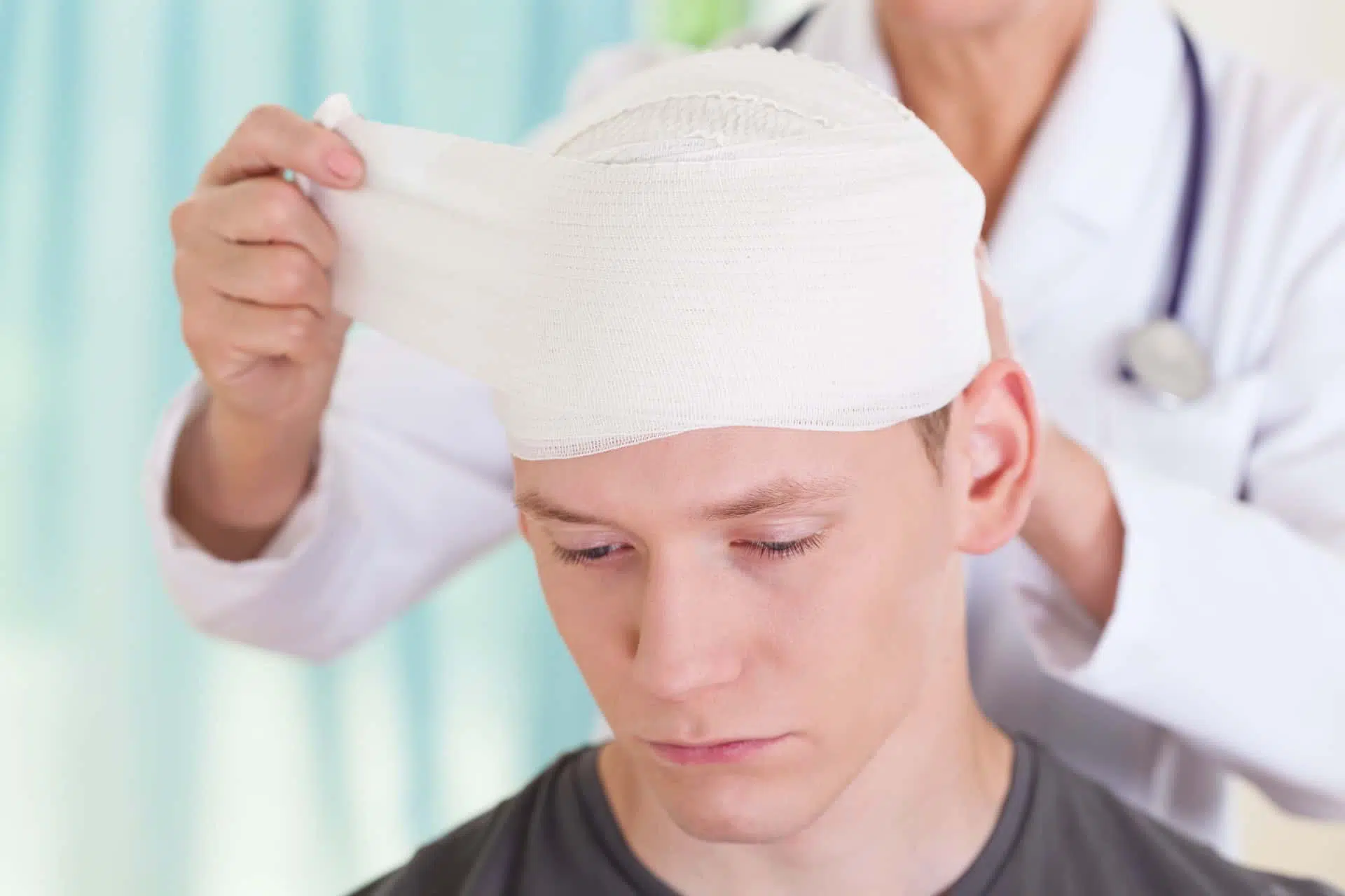Young man getting head wrapped after a tragic personal injury